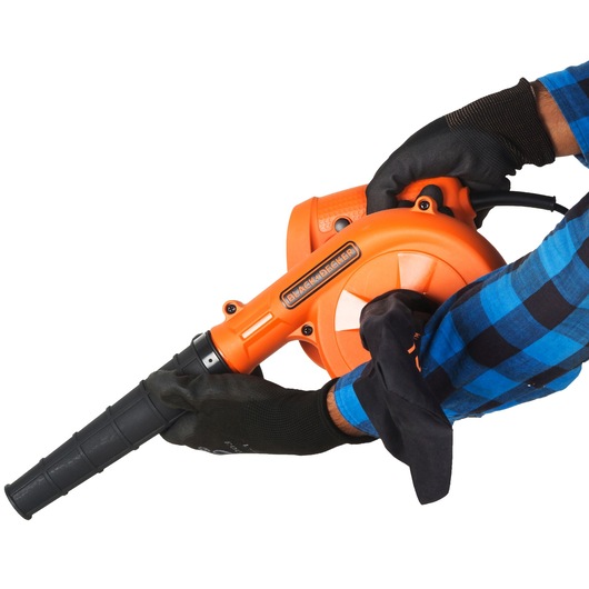 BLACKDECKER BDB530 orange handheld blower held by gloved hands, side angle, white background.