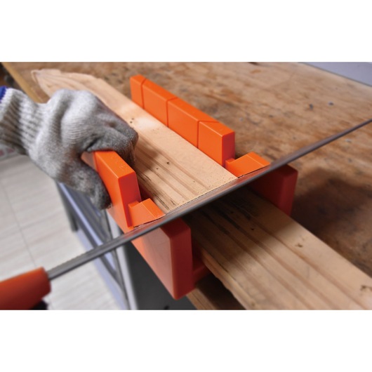 BLACKDECKER BDHT20346 orange plastic mitre box used for guiding a saw to cut wood at precise angles.