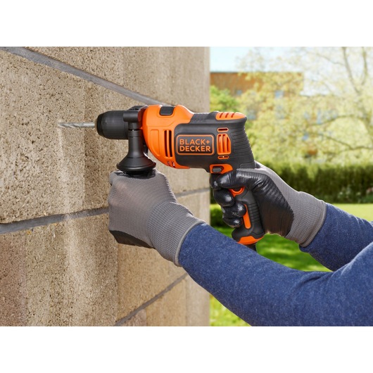 Photo of BLACKDECKER BEH710 corded hammer drill used on exterior brick wall.