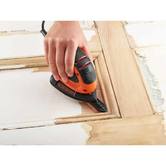 Photo of BLACKDECKER BEW230BC detail sander removing paint from wood surface.