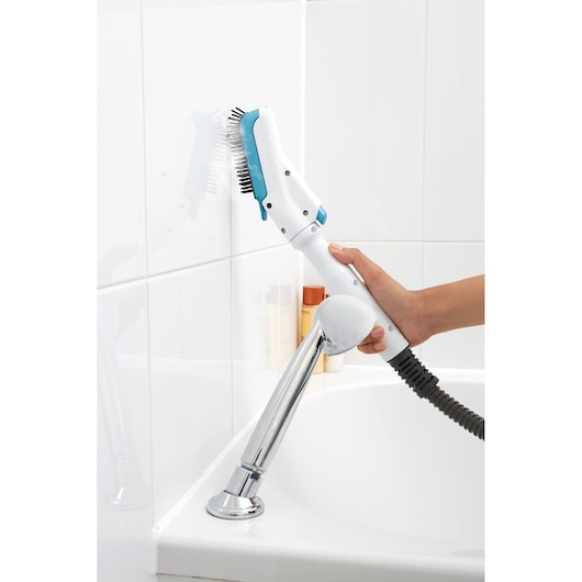 BLACKDECKER FSMH13101SM steam cleaner with brush head cleaning white bathroom tiles.