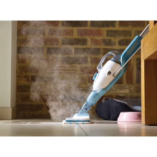 BLACKDECKER FSMH1351SM steam mop cleaning tiled floor, handheld steamer visible with steam rising.